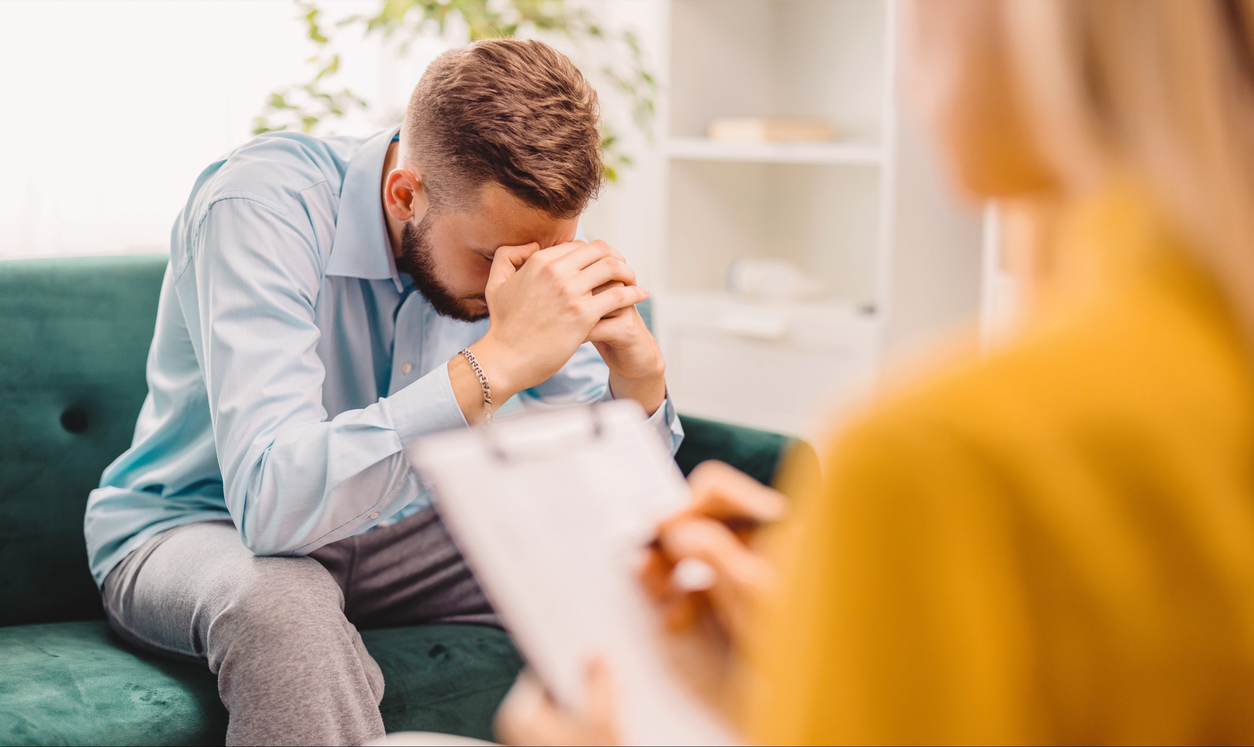 Alt Text: thoughtful man in therapy session reflecting on emotional recovery